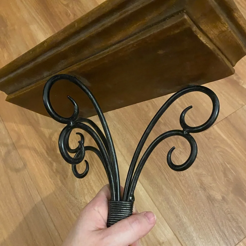 Brown and black iron and wood wall shelf